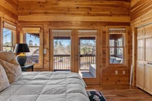 a bedroom with a bed in a room with wooden walls at Johnny's Lakeside Hideaway in Morganton