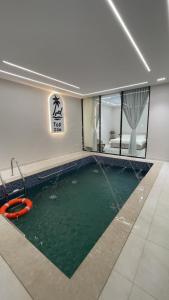 a swimming pool in the middle of a room at top one in Taif