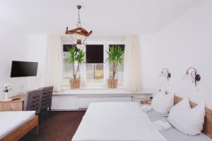 a living room with two beds and a window at Gostišče Krivograd in Prevalje