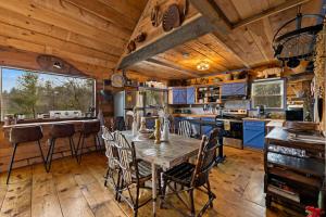 a kitchen with a table and chairs in a cabin at Bigfoot's Hideout in Blue Ridge