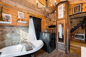 a bathroom with a tub and a sink in a cabin at Bigfoot's Hideout in Blue Ridge +42 photos