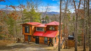 a cabin in the woods with a red roof at Bigfoot's Hideout in Blue Ridge