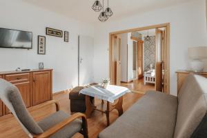 a living room with a couch and chairs and a table at Willa Sarenka in Międzyzdroje