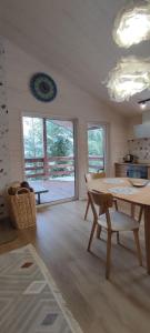 a living room with a table and chairs and a balcony at Садиба Пташка in Krivopolʼye