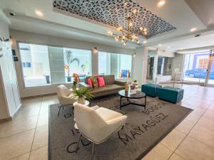 a living room with a couch and chairs and a table at TRYP by Wyndham Mayaguez in Mayaguez
