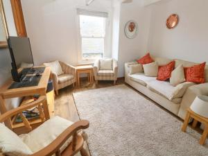 a living room with a couch and a table at St Dominic Cottage in St Ives