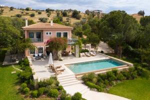 an aerial view of a house with a swimming pool at Aria & Iris in Kilada