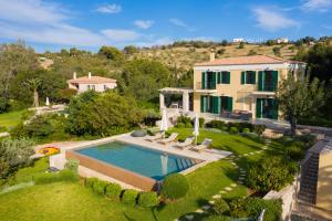 an aerial view of a house with a swimming pool at Aria & Iris in Kilada