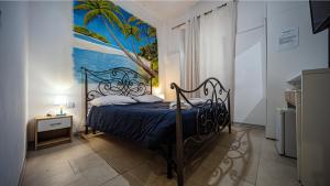 a bedroom with a bed with a painting on the wall at Bed Rho Stazione - Fiera in Rho