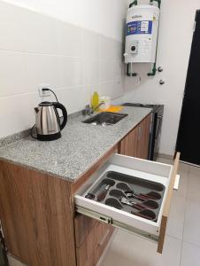 a kitchen with a sink and a stove top oven at Complejo La Mística in Copacabana