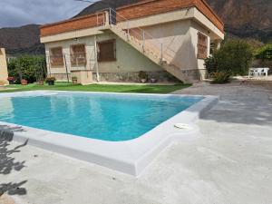 a house with a swimming pool in front of a house at La Casa de la Huerta de Redován in Redován