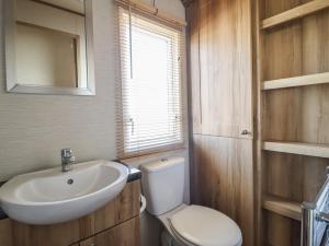a bathroom with a white toilet and a sink at 23 Gull Court in Porthmadog +10 photos