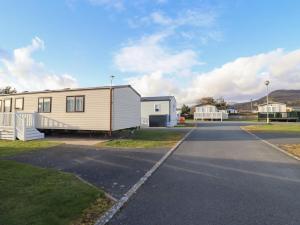 a mobile home parked on the side of a road at 23 Gull Court in Porthmadog