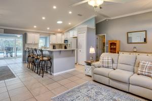 a living room with a couch and a kitchen at Saltwater Pool! Sebring Oasis Near Lake Jackson in Sebring