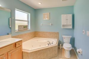 a bathroom with a tub and a toilet and a sink at Saltwater Pool! Sebring Oasis Near Lake Jackson in Sebring +20 photos