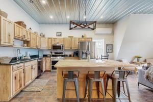 a kitchen with wooden cabinets and a large island with bar stools at Valley Vista Vacay in Littleton