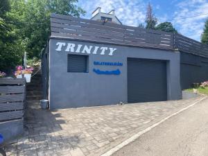 a building with the words trinity written on it at Trinity in Balatonalmádi