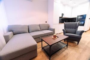 a living room with a couch and two chairs at ApartHouse in Klimontów +26 photos