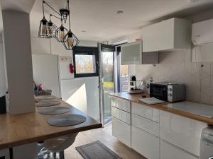 a kitchen with white cabinets and a counter top at Trinity in Balatonalmádi