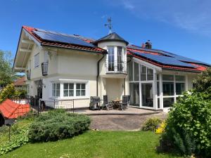 a house with solar panels on the roof at Landhaus am Bach in Sulzberg