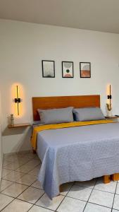 a bedroom with a large bed with three pictures on the wall at Star Department We bill in La Paz
