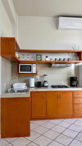 a kitchen with wooden cabinets and a microwave at Star Department We bill in La Paz