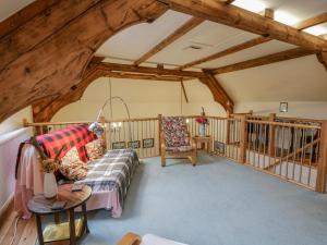 a living room with a couch and chairs in a room at Yr Hen Ysgoldy in Machynlleth