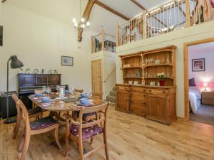 a dining room with a table and a bedroom at Yr Hen Ysgoldy in Machynlleth