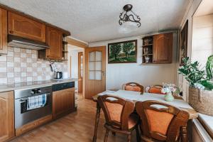 a kitchen with a table and chairs in a kitchen at Willa Sarenka in Międzyzdroje