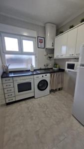 a kitchen with a stove and a dishwasher at Apartamento Gaztelugatxe in Bakio +1 photo