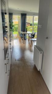 a kitchen and living room with a table and chairs at Chalet Pallegarste 153 in Mariënberg