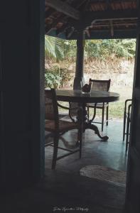 a table and chairs in a room with a table at Catumaran Jaffna in Jaffna