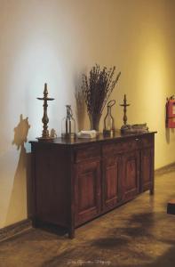 a wooden cabinet with vases on top of it at Catumaran Jaffna in Jaffna
