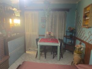 a table and chairs in a room with a table and a table and a table at Home Room in San Pietro Avellana