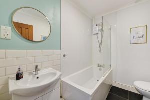a white bathroom with a sink and a mirror at 3 Bed in Croyde oc-2ingle in Croyde +17 photos