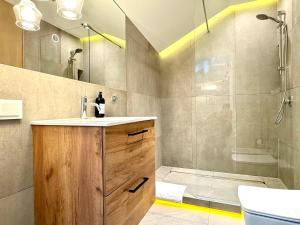 a bathroom with a sink and a shower at MINT Luxury Apartments at the Main Square in Krakow