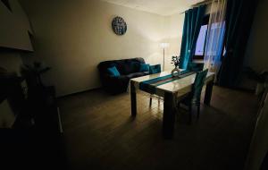 a living room with a table and a couch at Casa Sandalia in Villacidro