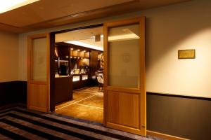 an open glass door in a room with a bar at Royal Park Hotel Takamatsu in Takamatsu