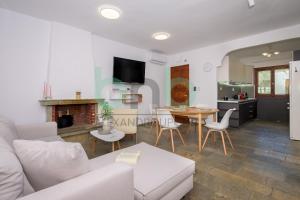 a living room with a couch and a table at Elaion House in Agia Paraskevi