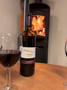 a bottle of wine next to a glass of red wine at La Rose d Eva in Saint-Martin