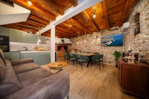 a living room with a couch and a table at Stone House Dida Toni Tribunj in Tribunj