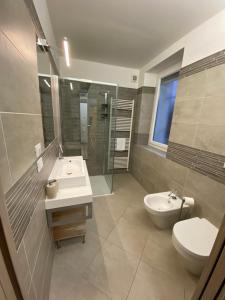 a bathroom with a sink and a toilet and a shower at Maison Federica in Colà di Lazise