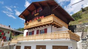 a building with a wooden balcony on top of it at La Rose d Eva in Saint-Martin