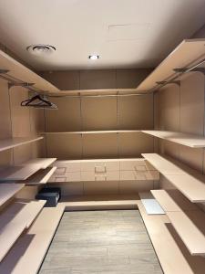 an empty room with shelves and lights in it at Pearl Properties three bedroom apartment in Trofwi