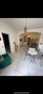a living room with a table and chairs at Nid douillet in Montpellier