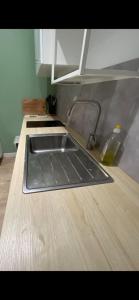 a sink in a kitchen with a wooden counter top at Nid douillet in Montpellier