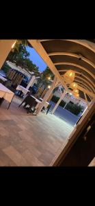 a view of a patio with tables and chairs at Hôtel de la Mer - Barcarès, à 100 m de la plage in Le Barcarès