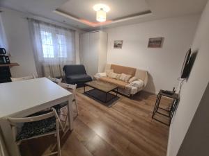 a living room with a couch and a table at Oasis City Central in Tarnowskie Góry