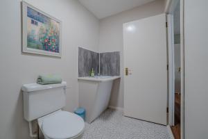 a white bathroom with a toilet and a sink at Castle Inn in Newtownstewart +19 photos