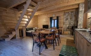 a kitchen and dining room with a table and chairs at Vila Kraljica Planina in Šavnik